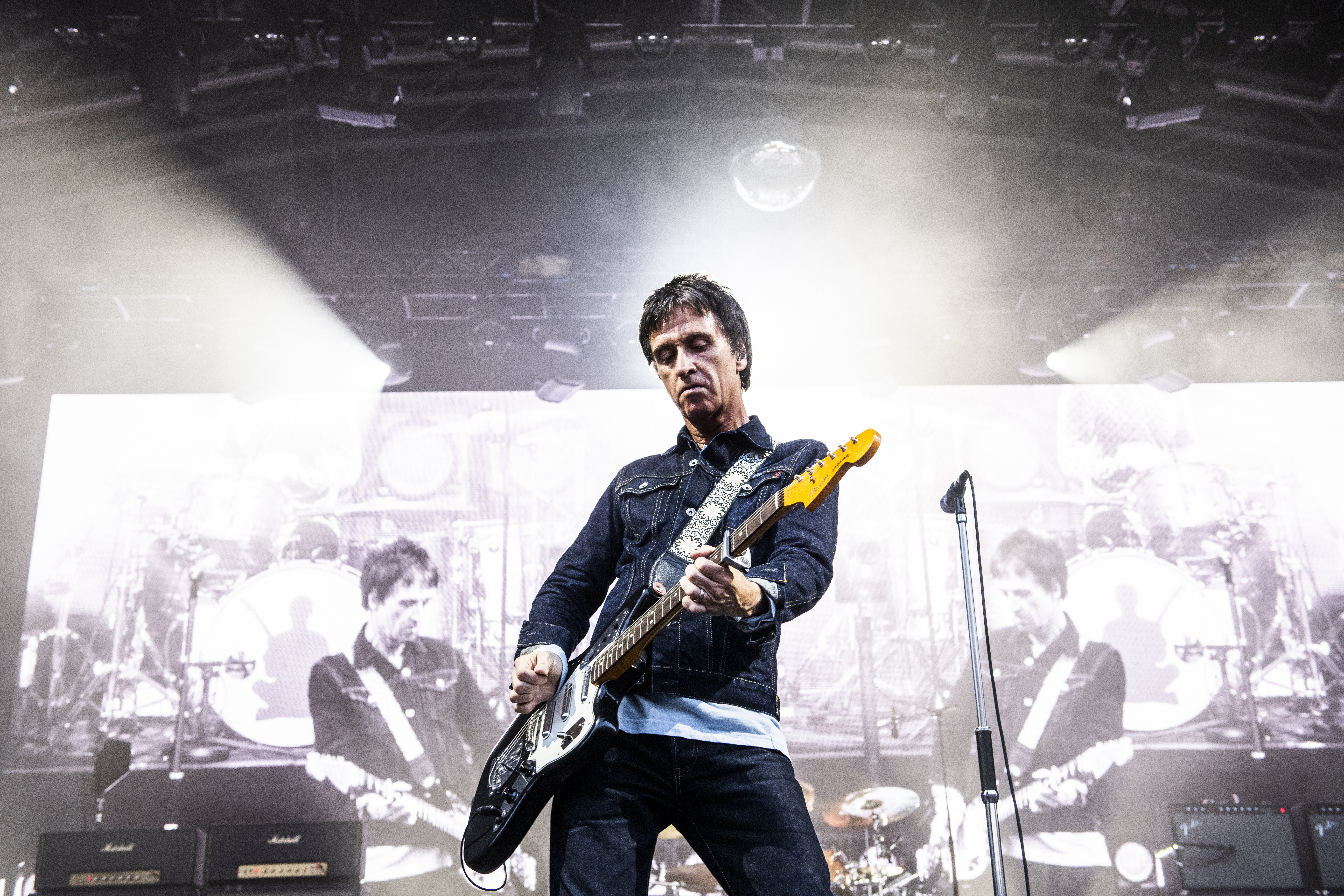 Johnny Marr on stage performing at Castlefield Bowl