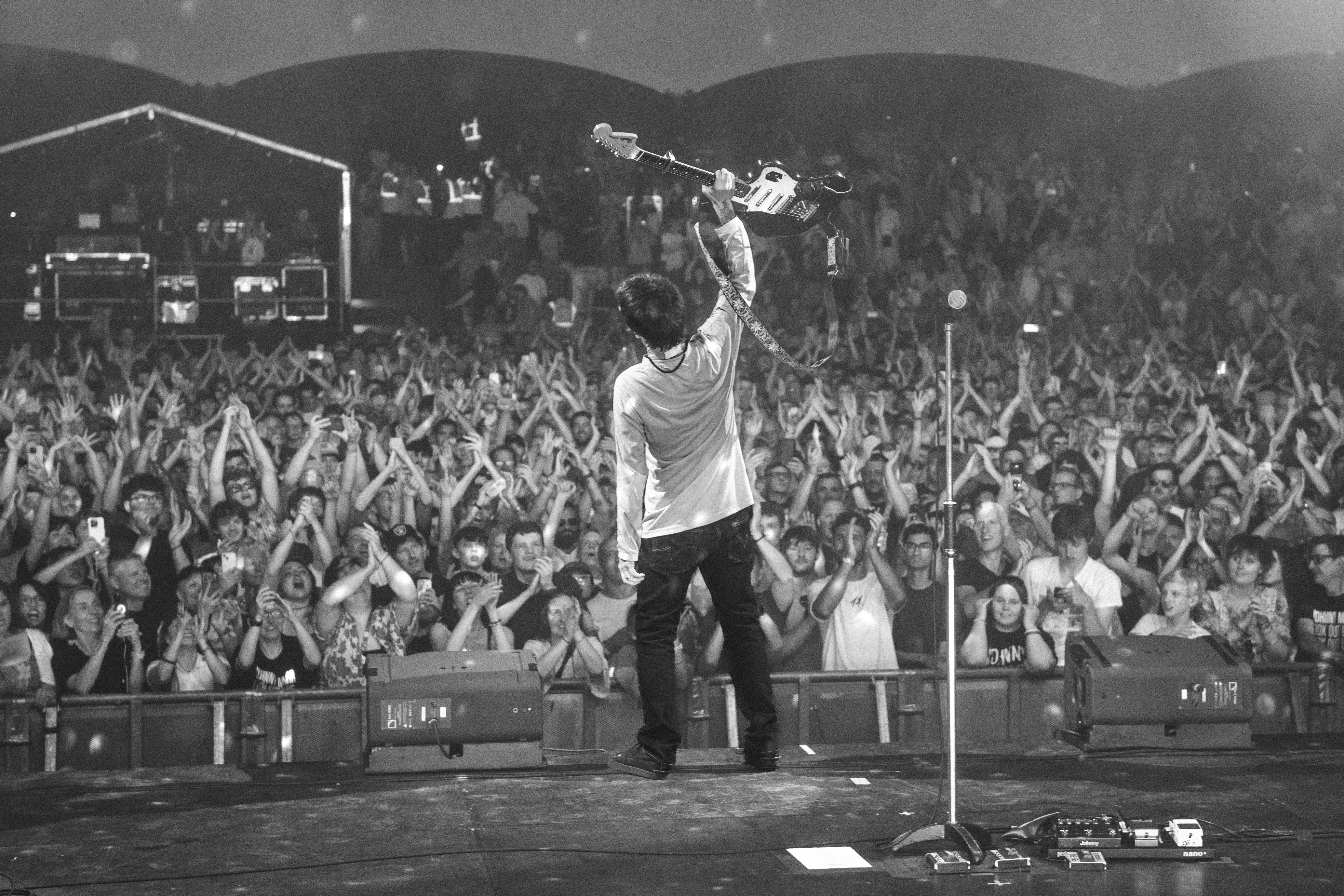 Johnny Marr raises his guitar to the Castlefield Bowl crowd