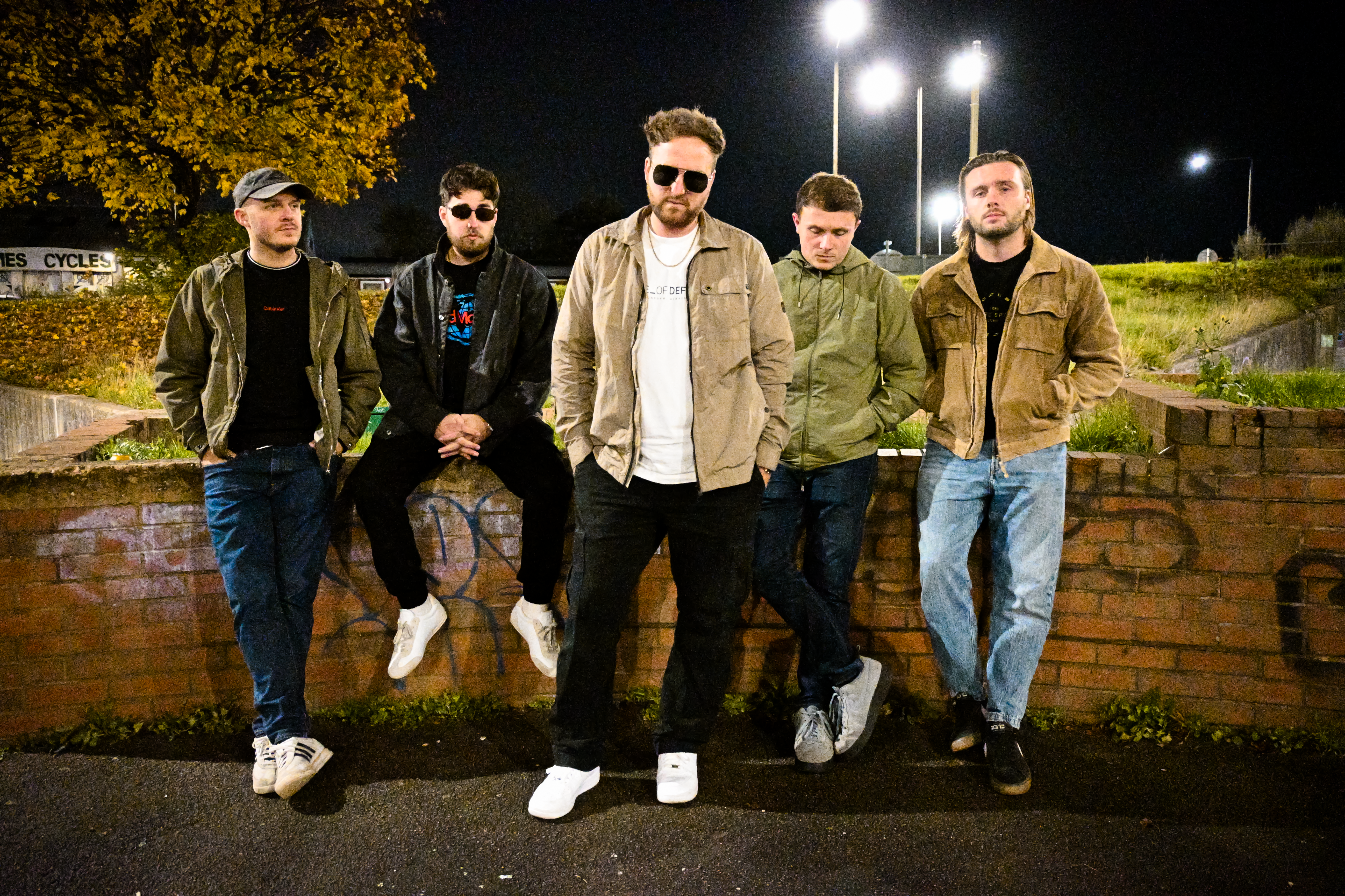 The Crooks stood outside under dim lighting